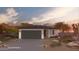 Charming single-story home featuring desert landscaping, a two-car garage, and a welcoming entrance at 17165 N Lariat Rd, Maricopa, AZ 85138