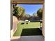 Charming backyard with artificial grass, picnic table, and mature trees, providing a private outdoor retreat at 17225 W Carmen Dr, Surprise, AZ 85388