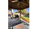 Backyard patio with outdoor kitchen, hammock and artificial turf at 17225 W Carmen Dr, Surprise, AZ 85388