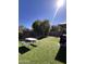Well-maintained backyard with artificial grass, patio area, and barbecue, ideal for outdoor gatherings at 17225 W Carmen Dr, Surprise, AZ 85388