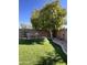 Backyard features a shady tree and seating area, with artificial turf at 17225 W Carmen Dr, Surprise, AZ 85388