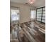 Bright bedroom featuring a mirrored closet, windows with bright light, and wood-look tile flooring at 17225 W Carmen Dr, Surprise, AZ 85388