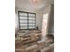 Comfortable bedroom with modern mirrored closet, wood-look tile floors, and access to an ensuite bathroom at 17225 W Carmen Dr, Surprise, AZ 85388