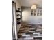 Dining area with stylish wood-look tile flooring, modern pendant lighting, and decorative shelving at 17225 W Carmen Dr, Surprise, AZ 85388