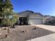 Well-maintained single-story home featuring desert landscaping, a two-car garage, and a neatly kept exterior at 17225 W Carmen Dr, Surprise, AZ 85388