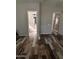 Hallway featuring wood-look tile flooring and doorways to the bathroom and bedroom, creating a cohesive and functional space at 17225 W Carmen Dr, Surprise, AZ 85388