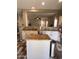 Bright kitchen featuring granite countertops, stainless steel appliances, a center island, and wood-look tile flooring at 17225 W Carmen Dr, Surprise, AZ 85388