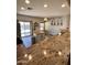 Open kitchen featuring granite countertops, an island with storage, and seamlessly flowing into a dining area with a sliding door at 17225 W Carmen Dr, Surprise, AZ 85388