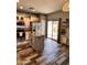 Modern kitchen featuring stainless steel appliances, granite countertops, a center island, and wood-look tile flooring at 17225 W Carmen Dr, Surprise, AZ 85388