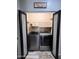 Modern laundry room with washer and dryer, shelving, and double doors, designed for efficient laundry management at 17225 W Carmen Dr, Surprise, AZ 85388