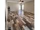 Spacious living room featuring wood-look tile flooring, neutral color scheme, and abundant natural light at 17225 W Carmen Dr, Surprise, AZ 85388