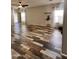 Bright living room with wood-look tile floors, ceiling fan, and neutral walls, offering a welcoming and airy atmosphere at 17225 W Carmen Dr, Surprise, AZ 85388