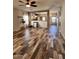Well-lit living room with wood-look tile floors seamlessly connects to the kitchen, offering an open and inviting space at 17225 W Carmen Dr, Surprise, AZ 85388