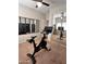 Workout room with stationary bike, large mirror, and framed motivational prints at 17225 W Carmen Dr, Surprise, AZ 85388