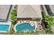 Aerial view showcasing a kidney-shaped pool with a lounge area, fire pit, and landscaped yard at 19002 N Arbor Dr, Maricopa, AZ 85138