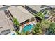 Aerial view of a property featuring a covered patio, a pool, outdoor lounge area, and a well-maintained yard at 19002 N Arbor Dr, Maricopa, AZ 85138