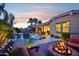 Inviting backyard with a sparkling pool, lounge chairs, a cozy fire pit area, and lush landscaping for ultimate relaxation and enjoyment at 19002 N Arbor Dr, Maricopa, AZ 85138