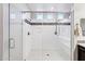 Modern bathroom with seamless glass shower, integrated bench, and tiled showerhead at 19002 N Arbor Dr, Maricopa, AZ 85138