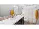 Clean bathroom featuring a modern vanity, bright lighting, and a shower-tub combo for convenience at 19002 N Arbor Dr, Maricopa, AZ 85138