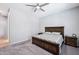 Cozy bedroom features a king bed, ceiling fan, and soft carpet for a relaxing retreat at 19002 N Arbor Dr, Maricopa, AZ 85138