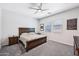 Well-lit bedroom with ceiling fan and large bed frame at 19002 N Arbor Dr, Maricopa, AZ 85138