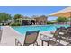 Community pool with lounge chairs, cabana, and beautiful landscaping, providing a resort-style experience at 19002 N Arbor Dr, Maricopa, AZ 85138