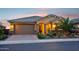 Beautiful single story home featuring a well manicured yard with desert landscaping, a large garage, and a covered porch at 19002 N Arbor Dr, Maricopa, AZ 85138