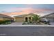 Home featuring a well manicured yard with desert landscaping, a large garage, and a covered porch at 19002 N Arbor Dr, Maricopa, AZ 85138