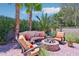 Cozy outdoor seating area with a fire pit, comfortable seating, and lush landscaping, creating a relaxing ambiance at 19002 N Arbor Dr, Maricopa, AZ 85138