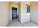 Charming entrance featuring a dark wood door with decorative wreath, enhancing the home's curb appeal at 19002 N Arbor Dr, Maricopa, AZ 85138