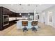 Modern kitchen with island, breakfast bar, granite countertops, and stainless appliances at 19002 N Arbor Dr, Maricopa, AZ 85138