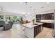 Spacious open concept with chef's kitchen, seamless island, and cozy living space at 19002 N Arbor Dr, Maricopa, AZ 85138