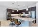 Modern kitchen with island, breakfast bar, granite countertops, and stainless appliances at 19002 N Arbor Dr, Maricopa, AZ 85138
