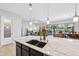 Gourmet kitchen island with granite counters, undermount sink, and views of the backyard at 19002 N Arbor Dr, Maricopa, AZ 85138