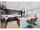 Modern kitchen with island, breakfast bar, granite countertops, and stainless appliances at 19002 N Arbor Dr, Maricopa, AZ 85138