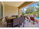 Covered patio with dining table and chairs overlooks the pool with chaise lounges, creating an inviting outdoor space at 19002 N Arbor Dr, Maricopa, AZ 85138
