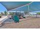 Community playground featuring slides, climbing structures, swings, and covered shade for outdoor fun at 19002 N Arbor Dr, Maricopa, AZ 85138