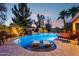 Resort-style pool featuring dual waterfalls, Baja shelf, and mature desert landscaping at 19002 N Arbor Dr, Maricopa, AZ 85138