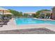 Community pool area featuring refreshing blue water, lounge chairs, umbrellas, and a gazebo at 19002 N Arbor Dr, Maricopa, AZ 85138