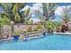 Stunning backyard showcasing a beautiful pool with water features and lush landscaping, creating a tranquil outdoor space at 19002 N Arbor Dr, Maricopa, AZ 85138