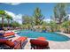 Beautiful backyard pool area with lounge chairs and tropical landscaping perfect for relaxing and entertaining at 19002 N Arbor Dr, Maricopa, AZ 85138