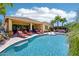 Gorgeous backyard with a sparkling pool, covered patio, lounge chairs, and lush landscaping, perfect for outdoor entertaining at 19002 N Arbor Dr, Maricopa, AZ 85138