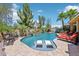 Incredible backyard with a sparkling pool, water features, lounge chairs, and lush landscaping, perfect for relaxation and enjoyment at 19002 N Arbor Dr, Maricopa, AZ 85138