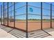 Fenced community softball field featuring well-maintained dirt infield and lush green grass at 19002 N Arbor Dr, Maricopa, AZ 85138