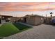 Outdoor backyard area featuring an outdoor kitchen, artificial grass, and paver patio at 19615 N 18Th Dr, Phoenix, AZ 85027