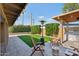 Outdoor living space with artificial turf, barbecue area and relaxing patio furniture at 19615 N 18Th Dr, Phoenix, AZ 85027