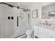 A modern bathroom showcasing a beautiful marble tiled shower with matte black hardware at 19615 N 18Th Dr, Phoenix, AZ 85027