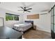 Bright bedroom features wood floors, ceiling fan, and abundant natural light from a large window at 19615 N 18Th Dr, Phoenix, AZ 85027