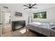 This bedroom features modern design with dark wood accents, a ceiling fan, and mounted TV at 19615 N 18Th Dr, Phoenix, AZ 85027