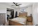 Cozy bedroom with wood floors, closet, ceiling fan and a large window at 19615 N 18Th Dr, Phoenix, AZ 85027